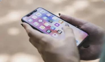 A person holding an iPhone he is development services, showcasing the latest technology in a modern setting, perfect for tech enthusiasts