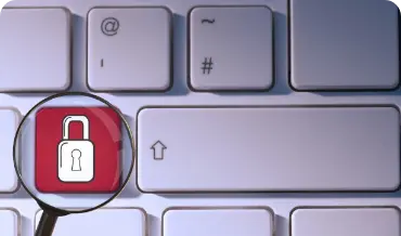 Image of a magnifying glass on a keyboard with a padlock, representing the importance of security in CakePHP applications.